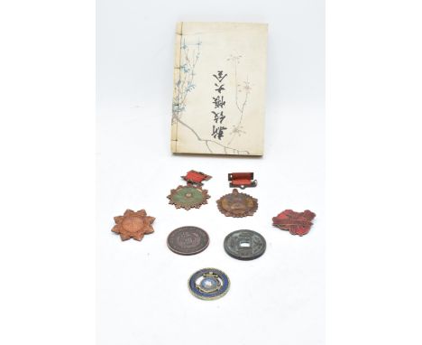 A collection of Chinese coins and medals together with a Japanese block print book. 