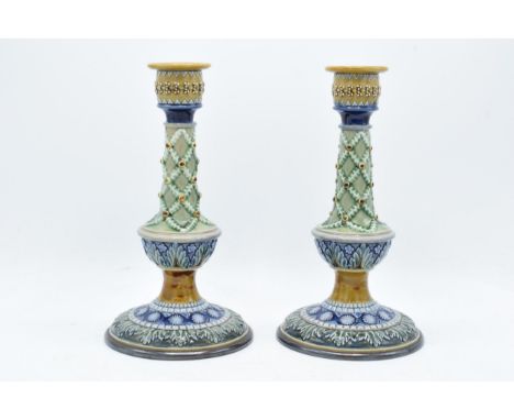 A pair of Doulton Lambeth candlesticks, circa 1880, with artist's monograms to base to include Bessie Newbury, E Wakley etc. 