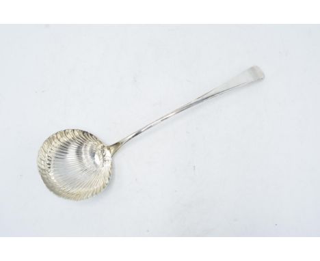 An antique silver ladle with shell decoration. 134.5 grams. Hallmarks rubbed. 