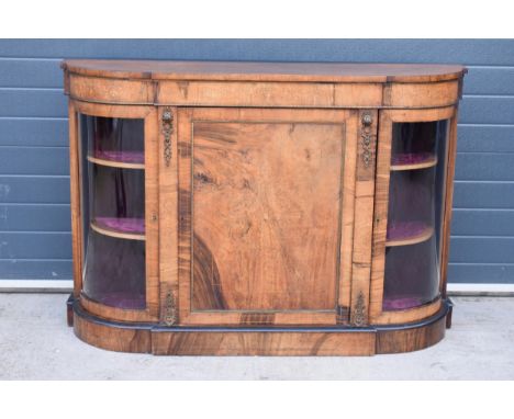 Victorian walnut breakfront credenza with an inlaid panel door flanked by bow glass doors enclosing two shelves with brass or