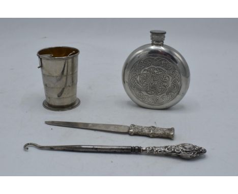 A mixed collection of items to include a pewter hipflask, chrome-plated collapsible cup, paper knife and a silver-handled but