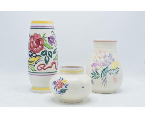 A collection of Poole Pottery to include tall footed vase, an ovoid vase 353 and a bulbous vase 438 (3) all decorated with fl