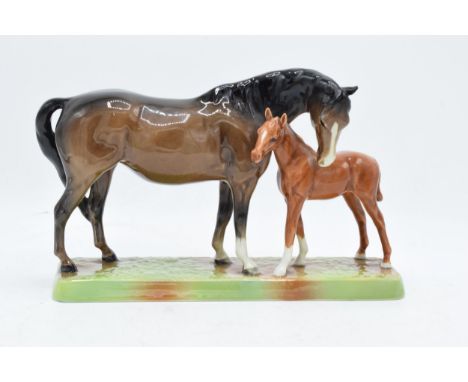 Beswick Mare and Foal on base: Beswick brown mare with Chestnut foal on ceramic grass base 1811. In good condition with no ob