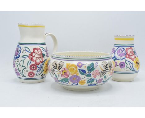 A trio of Poole Pottery items all in a similar floral pattern to include a bowl 422, a vase 266 and a tall jug (3). Tallest 1