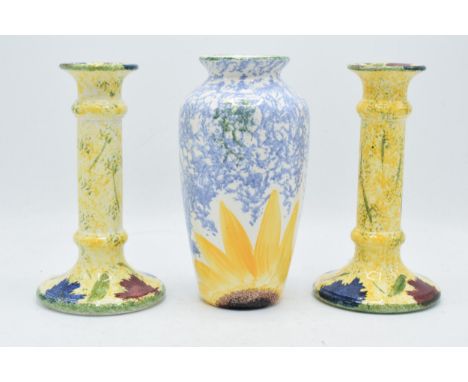 A collection of Poole Pottery items to the Feruccio design to include a pair of candlesticks and a bulbous vase (3). In good 