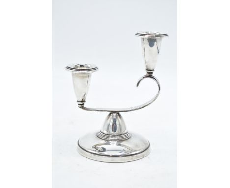 A double-sconce hallmarked silver candlestick. Birmingham 1963. 176.6 grams (loaded). 13cm tall. 
