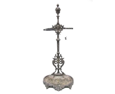 A Late Victorian Cast White Metal Stick Stand, the back with stylised serpents, scrolling foliage and central female mask to 