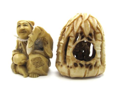 A Late XIX Century Japanese Ivory Netsuke, carved as a bearded gentleman holding an Oni mask and a hammer, signed, 3.5cm high