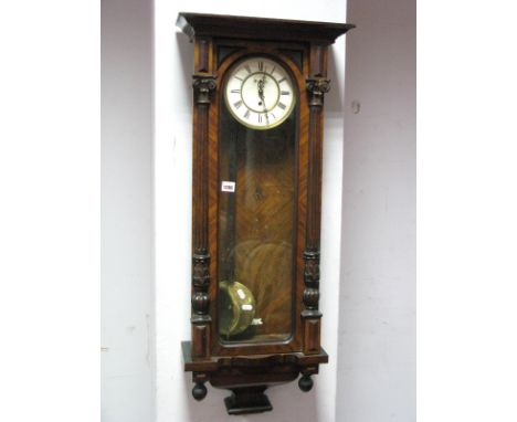 A XIX Century Walnut Vienna Wall Clock, with applied top, arched glazed door, half round column supports, shaped base, enamel