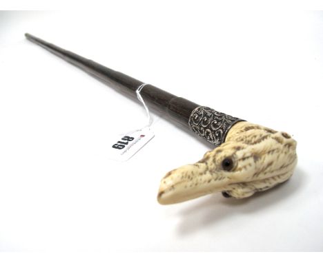 A Late XIX Century Walking Stick, the ivory handle carved as a dog, glass eyes, inscribed silver mounts, hallmarked for Londo