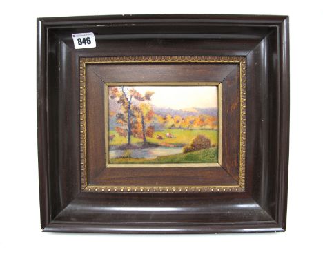 Camille Faure (1874-1956); A Limoges Enamel Rectangular Plaque, depicting cattle grazing before a river in a wooded landscape