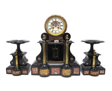 A Late XIX Century Black Slate and Rouge Marble Clock Garniture, the drum head with white enamel dial with Roman numerals, vi