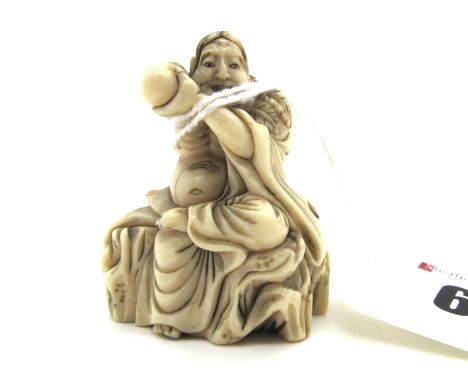 A Late XIX Century Japanese Ivory Netsuke, carved as a Sennin seated on a rock holding a gourd to his ear, 4cm high.