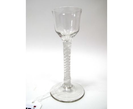 An XVIII Century Wine Glass, the ogee bowl raised on a white enamel twist stem and domed circular foot, 14.75cm high.