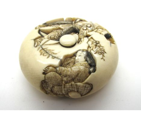 A XIX Century Japanese Manju Netsuke, carved with a warrior receiving a letter from a seated female attendant, signed, possib