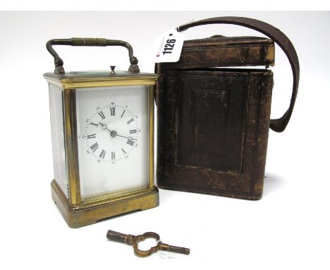 An Early XX Century Repeating Brass Cased Carriage Clock, the white enamel dial with Roman and Arabic numerals, fluted side c