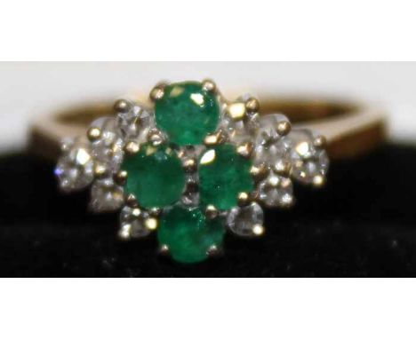 EMERALD AND DIAMOND DRESS RING
with a marquise shaped bezel, set with round emeralds, in eighteen carat gold