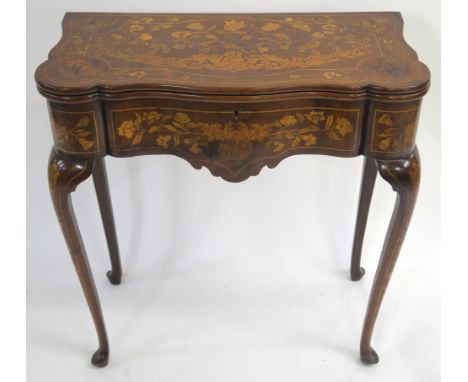 A DUTCH ROSEWOOD AND MARQUETRY CARD TABLE the twin hinged top inlaid with cherubs, birds and foliage, enclosing a baize top i