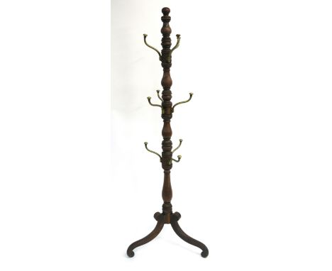 A VICTORIAN MAHOGANY HAT STAND the multi baluster turned column set with nine brass detachable scroll branches ,above scroll 