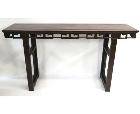 A CHINESE HARDWOOD ALTER TABLE with carved and pierced key pattern frieze set on squared legs inset with shaped frames, 95cm 