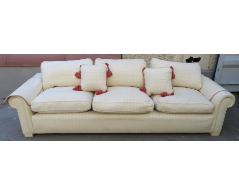 A LARGE CREAM HUMPBACK SOFA, with scatter cushions, 80cm high x 266cm wide x 90cm deep Condition Report: Available upon reque