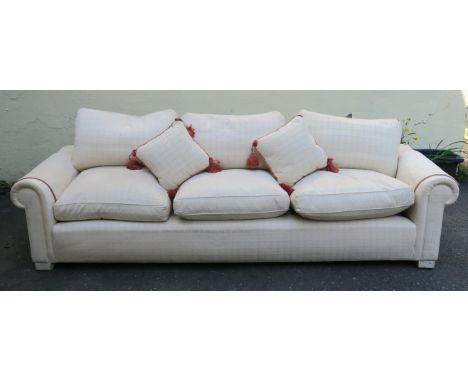 A LARGE CREAM HUMPBACK SOFA with scatter cushions, 80cm high x 266cm wide x 90cm deep Condition Report: Available upon reques