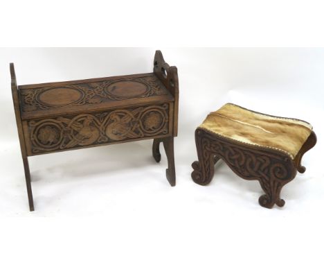 A CELTIC DESIGN OAK SEAT the carved hinged lid above interlaced animals and foliage, flanked by stylised bird uprights,66cm h