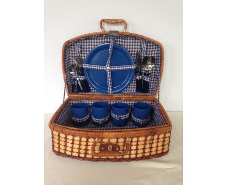 A vintage picnic hamper with plates, cups & cutlery.