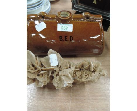 A ceramic bed warmer and mineral sample