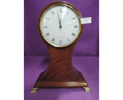 A battery operated mantle clock by Comitti of London