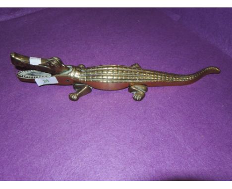 A brass nut cracker in the form of a crocodile