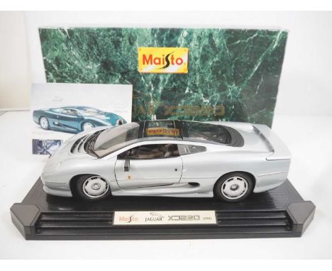 A MAISTO 1:12 scale model of a Jaguar XJ220 in silver - VG in G/VG box