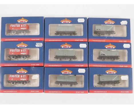A group of BACHMANN OO gauge wagons comprising 7 and 8 plank examples, all fitted with Kadee couplings in NEM pockets with or