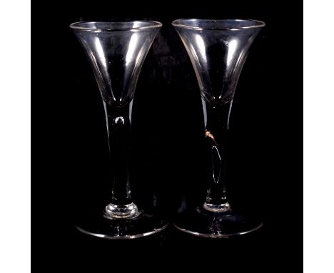 Wine glass, with drawn trumpet bowl, teared stem, conical foot, 16cm; and another of very similar profile, the teared stem cr