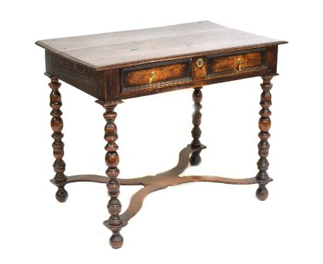 An old oak side table, in part early 18th century, boarded top, single frieze drawers, bobbin-turned supports, flat X-shape s