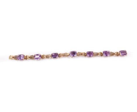 A 9ct gold and amethyst bracelet, set with seven emerald cut amethysts, on a snap clasp, 14.9g.