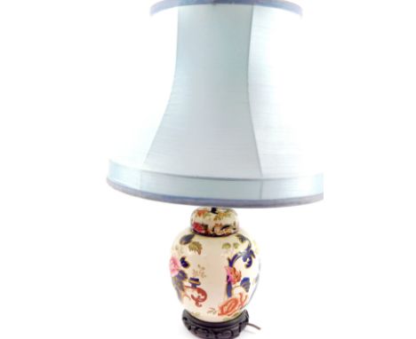 A Mason's ironstone table lamp decorated in the Mandalay pattern, of ginger jar and cover form, raised on a carved wooden bas