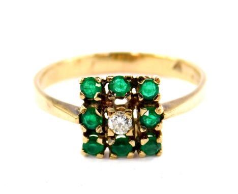 A 9ct gold emerald and diamond ring,  set with a central diamond in a surround of eight emeralds, in a square design, size R,