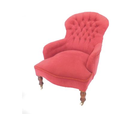 A Victorian mahogany spoon back nursing chair, with button back red dralon upholstery, raised on turned legs, capped on casto