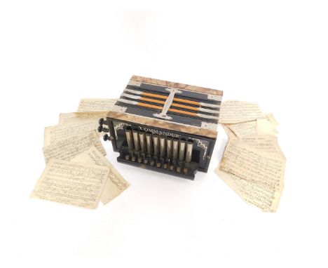 An early 20thC Commander accordion, ten button, boxed with sheet music.