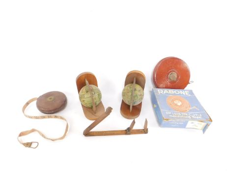 A Roberts of Sheffield folding boxwood ruler, Rabone Fibron measuring tape, boxed, and a pair of terrestial globe bookends. (