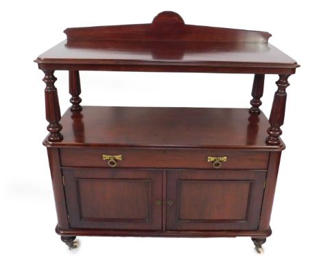 A Victorian mahogany buffet or waiter, having shelf back and moulded top, on taper reeded columns, over a single drawer and t