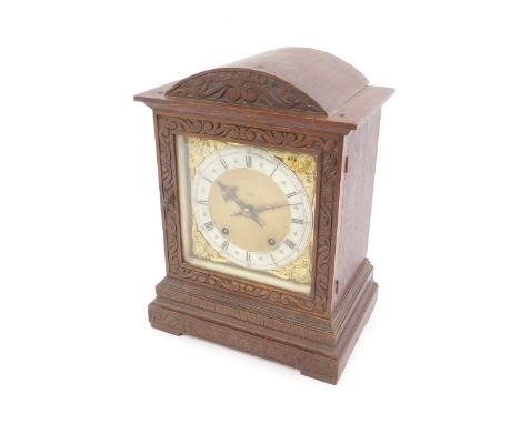 A German late 19thC oak cased mantel clock, square brass dial with cherub spandrels, silvered chapter ring bearing Roman nume