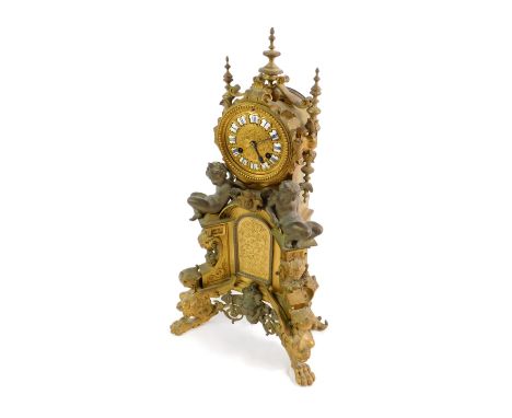 A late 19thC French ormolu mantel clock, the circular gilt and enamel dial bearing Roman numerals, eight day movement by Deni