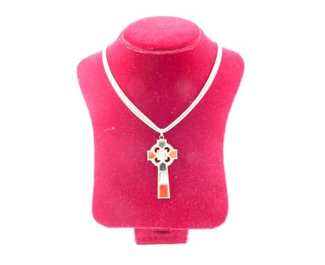 A Scottish agate set Celtic cross, in yellow metal with engraved floral and foliate decoration, on a double strand curb link 