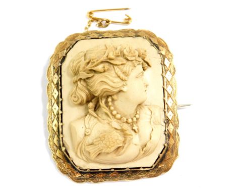 A late 19thC Continental  lava cameo brooch, decorated in high relief with a bust portrait of a lady, within a yellow metal f