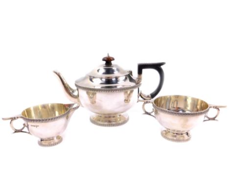 A George V silver three piece tea set, comprising teapot, cream jug and sugar bowl, Walker &amp; Hall, Sheffield 1912, 29.27o