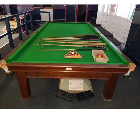 A full size mahogany and slate bed snooker table, 86cm H, 380cm W, 202cm D, together with over head light, cues, balls, etc. 