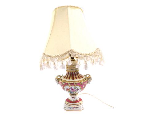 A Dresden 20thC porcelain table lamp, of twin ram's head baluster form, reserve decorated with flowers against a pink ground,