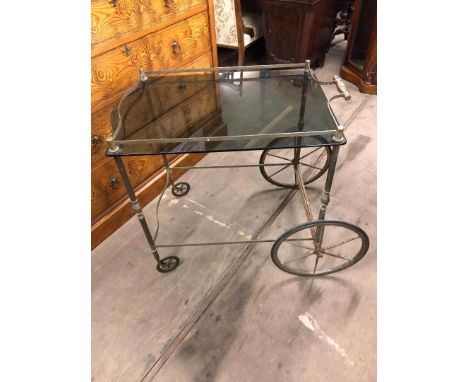 A vintage mid century brass drinks trolley, with smoked glass shelf, circa 1960's.